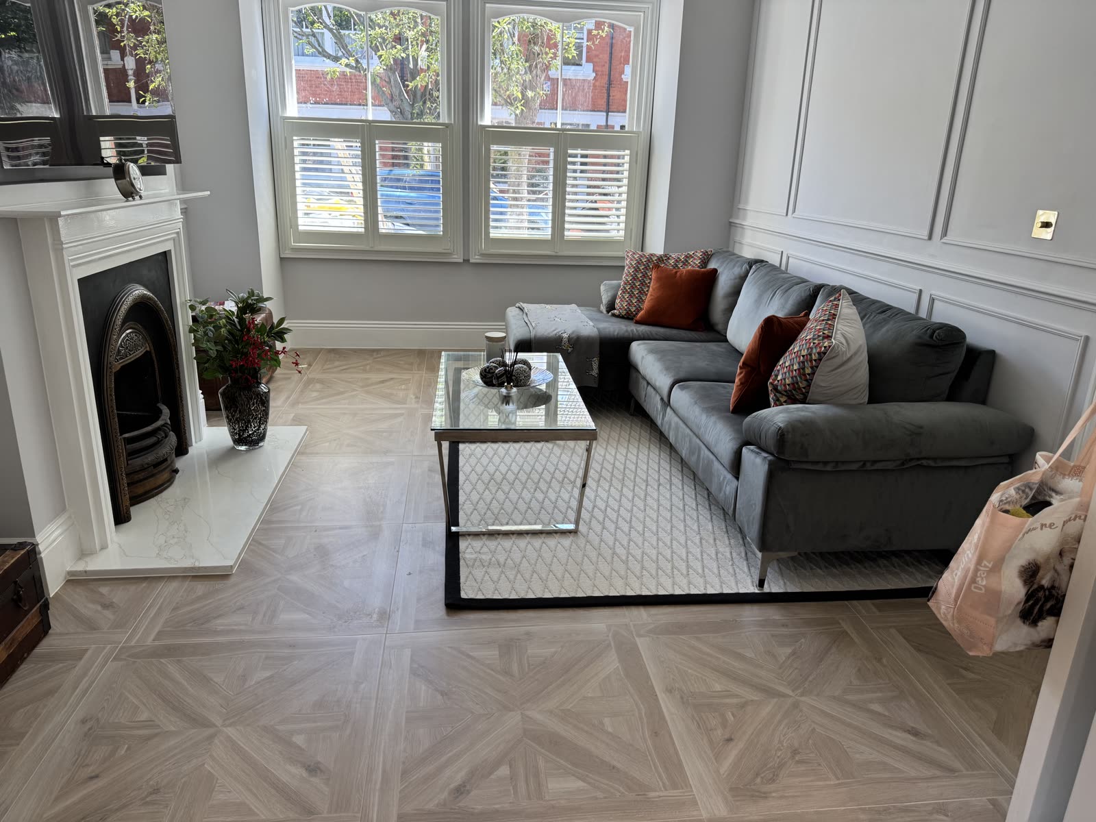 Living room with parquet flooring, cast-iron fireplace and panelled walls — Putney.