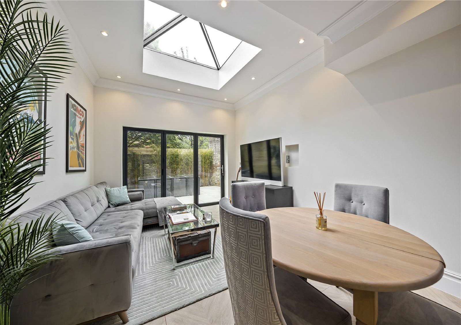 Open-plan living and dining under a skylight — Larkfield Road, Richmond.