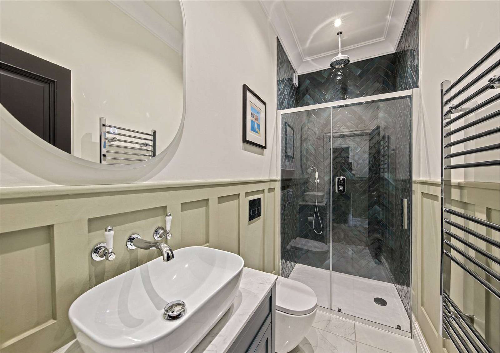 Walk-in shower room in matching green herringbone tile with single basin vanity — Flat 1.